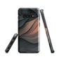 Phone case with flowing abstract design in black, copper and charcoal tones, inspired by dusk shadows
