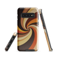 A retro-inspired phone case featuring warm swirling patterns in orange, yellow, and brown tones.