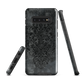 Dark damask patterned phone case with a vintage gothic aesthetic and textured stone background.