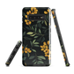 NZ Kowhai phone case with native yellow floral and green leaves on black background by designer Ben Hart.