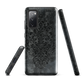 Dark damask patterned phone case with a vintage gothic aesthetic and textured stone background.
