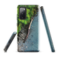 Resting Place phone case with aerial artwork of river rocks, green bush, and driftwood in a New Zealand stream.