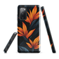 Phone case with bold orange bird of paradise flowers on dark background.
