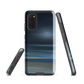 Dark abstract phone case with blue and grey streaks and glossy finish.