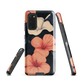 Phone case with coral hibiscus flowers and ivory blooms on dark background