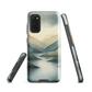 Phone case with soft mountain and valley design in misty green, blue, and golden tones