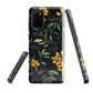 NZ Kowhai phone case with native yellow floral and green leaves on black background by designer Ben Hart.