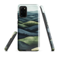 Phone case with layered mountain and forest landscape in blue and green hues