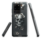 Gothic phone case with a floral skull design in grey tones, featuring white blossoms and dark detailing.