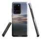 Phone case with tranquil lake scene at sunrise and distant hills.