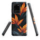 Phone case with bold orange bird of paradise flowers on dark background.