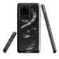 Phone case with detailed black python design on dark background.