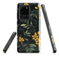 NZ Kowhai phone case with native yellow floral and green leaves on black background by designer Ben Hart.