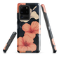 Phone case with coral hibiscus flowers and ivory blooms on dark background