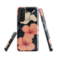 Phone case with coral hibiscus flowers and ivory blooms on dark background