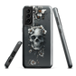 Gothic phone case with a floral skull design in grey tones, featuring white blossoms and dark detailing.
