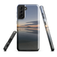 Phone case with tranquil lake scene at sunrise and distant hills.