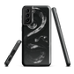 Phone case with detailed black python design on dark background.