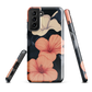 Phone case with coral hibiscus flowers and ivory blooms on dark background