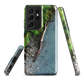 Resting Place phone case with aerial artwork of river rocks, green bush, and driftwood in a New Zealand stream.