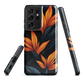 Phone case with bold orange bird of paradise flowers on dark background.
