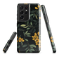 NZ Kowhai phone case with native yellow floral and green leaves on black background by designer Ben Hart.