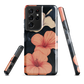 Phone case with coral hibiscus flowers and ivory blooms on dark background