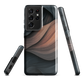 Phone case with flowing abstract design in black, copper and charcoal tones, inspired by dusk shadows
