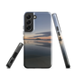 Phone case with tranquil lake scene at sunrise and distant hills.