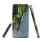 Resting Place phone case with aerial artwork of river rocks, green bush, and driftwood in a New Zealand stream.