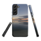 Phone case with tranquil lake scene at sunrise and distant hills.