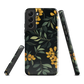 NZ Kowhai phone case with native yellow floral and green leaves on black background by designer Ben Hart.