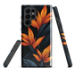 Phone case with bold orange bird of paradise flowers on dark background.