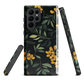 NZ Kowhai phone case with native yellow floral and green leaves on black background by designer Ben Hart.