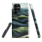 Phone case with layered mountain and forest landscape in blue and green hues