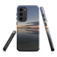 Phone case with tranquil lake scene at sunrise and distant hills.