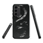 Phone case with detailed black python design on dark background.