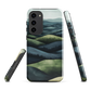 Phone case with layered mountain and forest landscape in blue and green hues