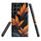 Phone case with bold orange bird of paradise flowers on dark background.