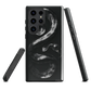 Phone case with detailed black python design on dark background.
