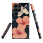 Phone case with coral hibiscus flowers and ivory blooms on dark background