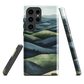 Phone case with layered mountain and forest landscape in blue and green hues