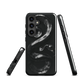 Phone case with detailed black python design on dark background.