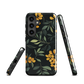 NZ Kowhai phone case with native yellow floral and green leaves on black background by designer Ben Hart.