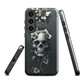 Gothic phone case with a floral skull design in grey tones, featuring white blossoms and dark detailing.