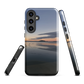 Phone case with tranquil lake scene at sunrise and distant hills.