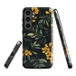 NZ Kowhai phone case with native yellow floral and green leaves on black background by designer Ben Hart.