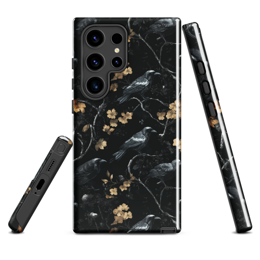 Dark phone case with blackbirds and gold blossoms on black branches.