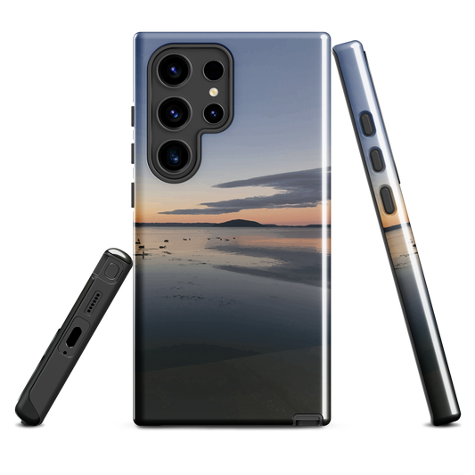 Phone case with tranquil lake scene at sunrise and distant hills.