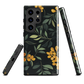 NZ Kowhai phone case with native yellow floral and green leaves on black background by designer Ben Hart.